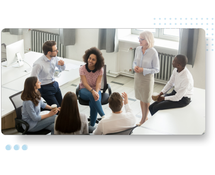 A diverse group of colleagues in casual attire gathers in an office setting for a relaxed discussion, focusing on HR audit strategies and compliance.